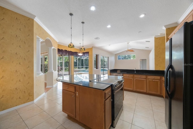 5519 Reflections Blvd, Lutz, FL 33558 - kitchen featuring black fridge, range with electric stovetop, dark countertops, a sink, and lofted ceiling