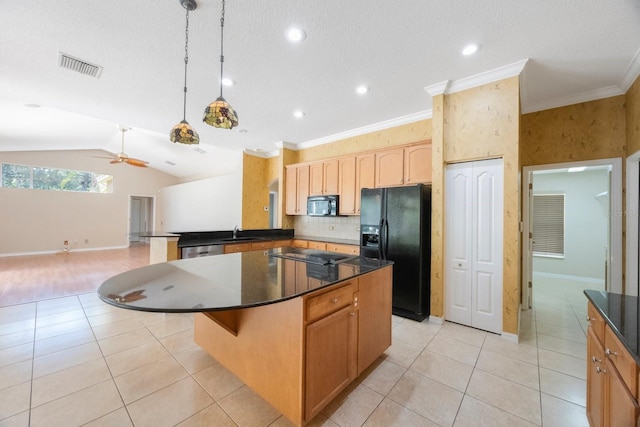 5519 Reflections Blvd, Lutz, FL 33558 - kitchen featuring black appliances, a sink, dark countertops, light tile patterned floors, and a peninsula