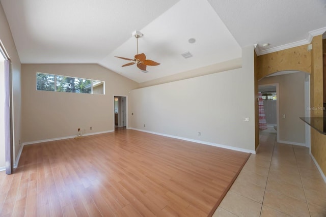 5519 Reflections Blvd, Lutz, FL 33558 - spare room featuring ceiling fan, arched walkways, vaulted ceiling, light wood finished floors, and baseboards