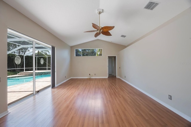 5519 Reflections Blvd, Lutz, FL 33558 - empty room featuring ceiling fan, vaulted ceiling, light wood finished floors, and baseboards