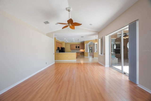 5519 Reflections Blvd, Lutz, FL 33558 - unfurnished living room with ceiling fan, light wood finished floors, lofted ceiling, and baseboards