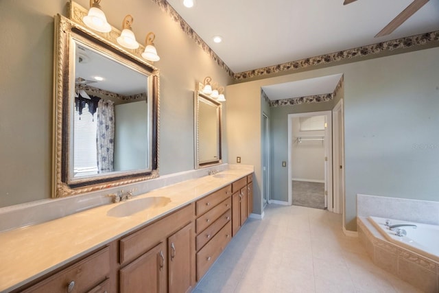 5519 Reflections Blvd, Lutz, FL 33558 - bathroom with double vanity, a bath, tile patterned flooring, a ceiling fan, and baseboards