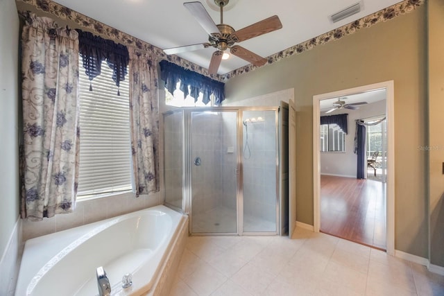 5519 Reflections Blvd, Lutz, FL 33558 - bathroom with a ceiling fan, a garden tub, a stall shower, baseboards, and tile patterned flooring