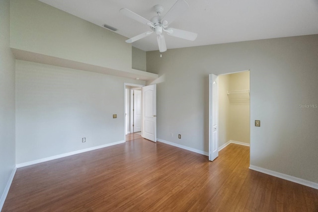5519 Reflections Blvd, Lutz, FL 33558 - unfurnished room with ceiling fan, wood finished floors, baseboards, and lofted ceiling