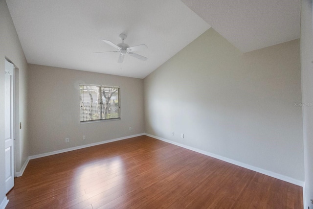 5519 Reflections Blvd, Lutz, FL 33558 - unfurnished room with wood finished floors, a ceiling fan, lofted ceiling, and baseboards