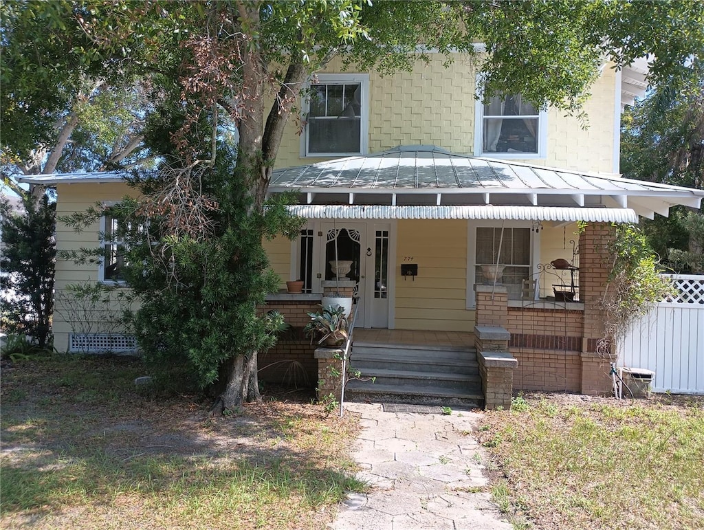 774 32nd Ave N, Saint Petersburg, FL 33704 - obstructed view of property featuring a porch, a standing seam roof, and metal roof