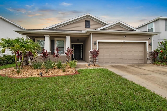 5006 Jackel Chase Dr, Wimauma, FL 33598 - view of front of house with concrete driveway, a front lawn, an attached garage, and covered porch