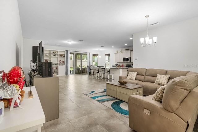 5006 Jackel Chase Dr, Wimauma, FL 33598 - living room featuring a chandelier, recessed lighting, and light tile patterned flooring