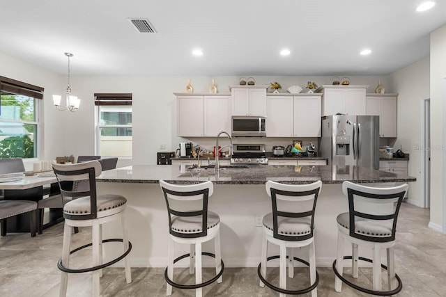 5006 Jackel Chase Dr, Wimauma, FL 33598 - kitchen featuring appliances with stainless steel finishes, a sink, a kitchen island with sink, a kitchen breakfast bar, and recessed lighting