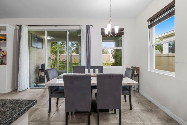 5006 Jackel Chase Dr, Wimauma, FL 33598 - dining area with a chandelier and baseboards