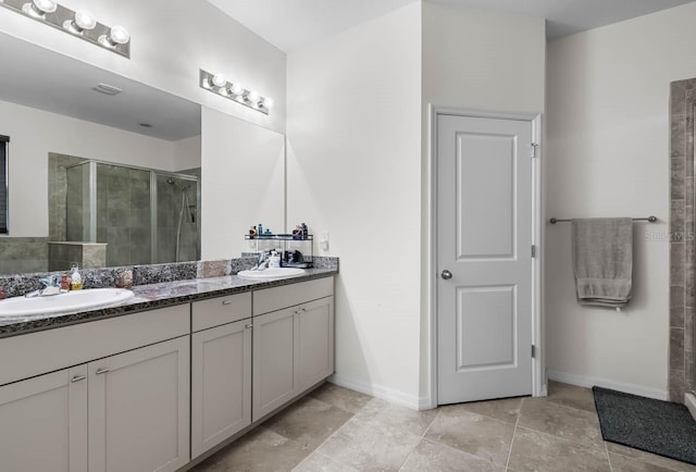 5006 Jackel Chase Dr, Wimauma, FL 33598 - bathroom featuring double vanity, a shower stall, and baseboards
