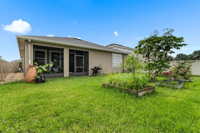 5006 Jackel Chase Dr, Wimauma, FL 33598 - rear view of property with a vegetable garden, a sunroom, and stucco siding