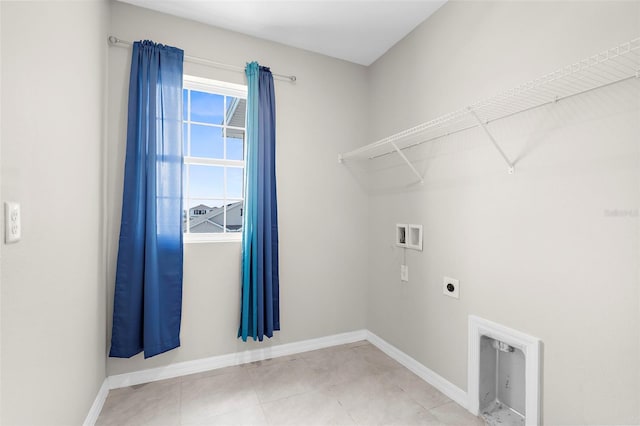 17005 Avon Dive Ln, Wimauma, FL 33598 - laundry room with hookup for a washing machine, electric dryer hookup, baseboards, and tile patterned floors