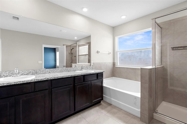 17005 Avon Dive Ln, Wimauma, FL 33598 - bathroom featuring tile patterned floors, a shower stall, a bath, double vanity, and recessed lighting