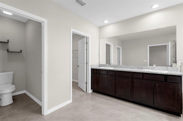17005 Avon Dive Ln, Wimauma, FL 33598 - full bath with toilet, double vanity, tile patterned floors, a spacious closet, and recessed lighting