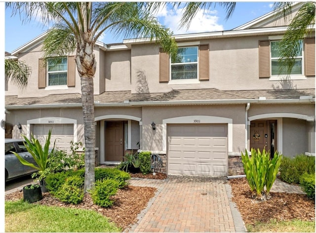 3901 Silverlake Way, Wesley Chapel, FL 33544 - view of property with an attached garage, stucco siding, and stone siding