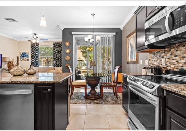 3901 Silverlake Way, Wesley Chapel, FL 33544 - kitchen with stainless steel appliances, crown molding, dark cabinets, light tile patterned floors, and backsplash