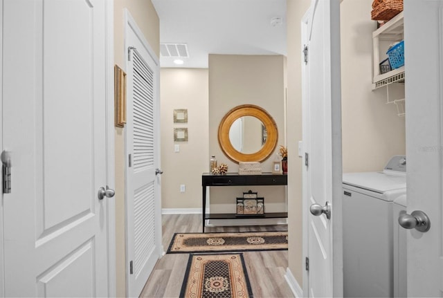 3901 Silverlake Way, Wesley Chapel, FL 33544 - hall featuring light wood-style floors, independent washer and dryer, baseboards, and recessed lighting
