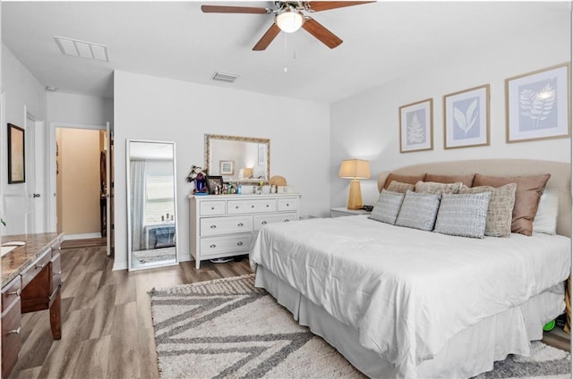 3901 Silverlake Way, Wesley Chapel, FL 33544 - bedroom featuring wood finished floors, a ceiling fan, and baseboards