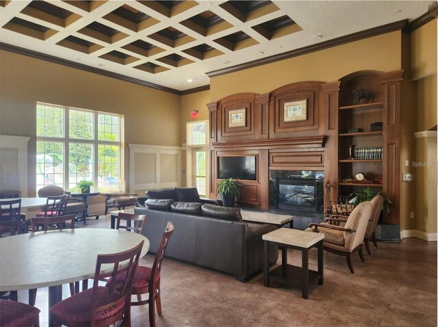 3901 Silverlake Way, Wesley Chapel, FL 33544 - living area with a fireplace, a towering ceiling, ornamental molding, coffered ceiling, and beam ceiling