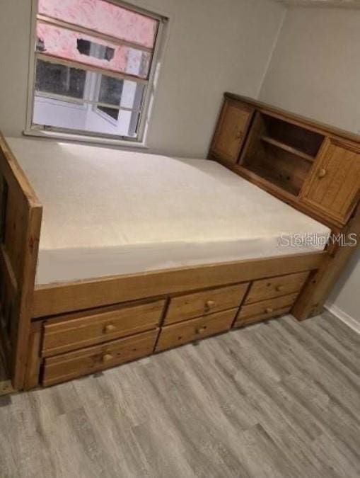 12828 SW 49th Ter, Webster, FL 33597 - bedroom featuring wood finished floors