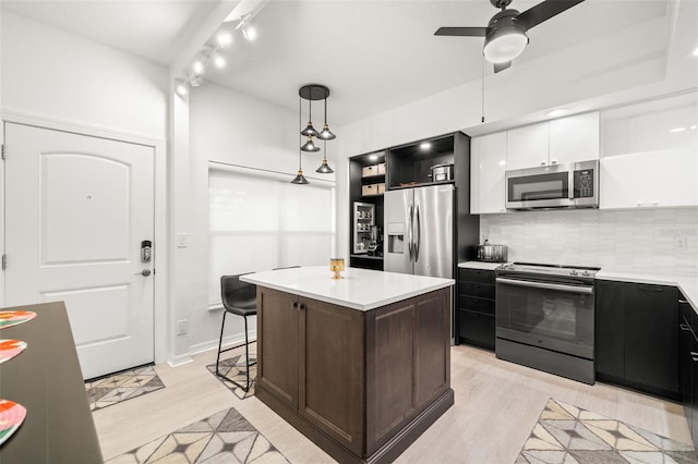 6330 99th Way N Unit 14B, Seminole, FL 33708 - kitchen with stainless steel appliances, white cabinetry, open shelves, and light countertops