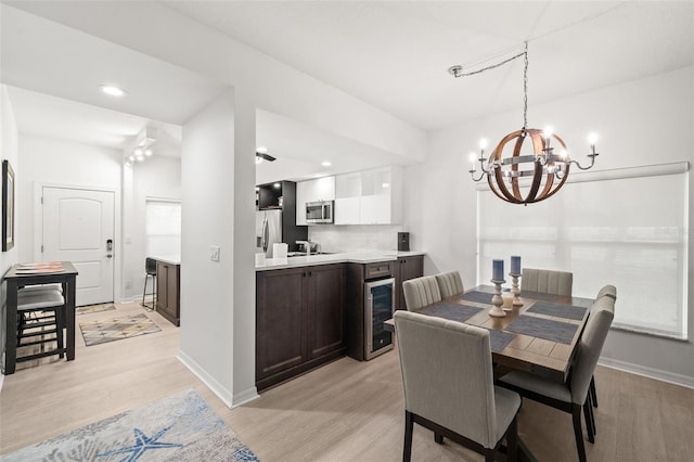 6330 99th Way N Unit 14B, Seminole, FL 33708 - dining room featuring a chandelier, light wood-type flooring, beverage cooler, baseboards, and recessed lighting