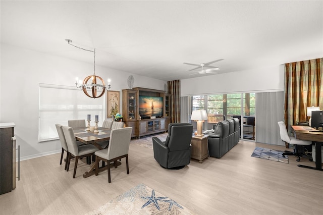 6330 99th Way N Unit 14B, Seminole, FL 33708 - dining area featuring light wood-type flooring, a chandelier, a desk, and a ceiling fan