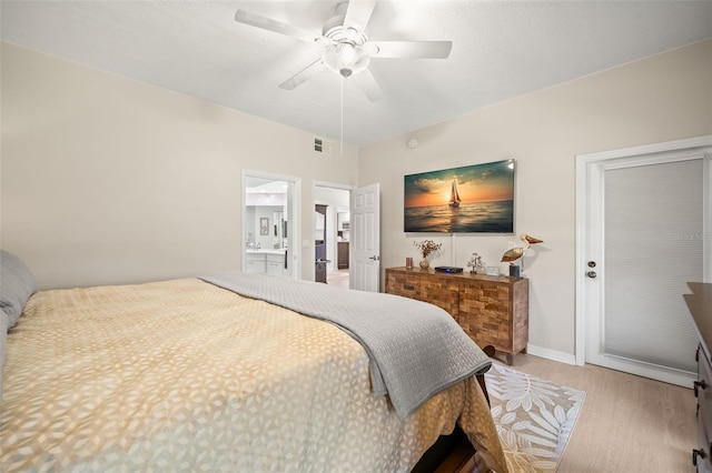 6330 99th Way N Unit 14B, Seminole, FL 33708 - bedroom featuring wood finished floors, a ceiling fan, baseboards, and connected bathroom
