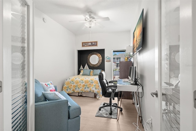6330 99th Way N Unit 14B, Seminole, FL 33708 - bedroom with a desk, wood finished floors, and ceiling fan