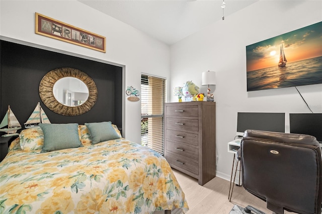 6330 99th Way N Unit 14B, Seminole, FL 33708 - bedroom with light wood-style flooring, a desk, baseboards, and lofted ceiling