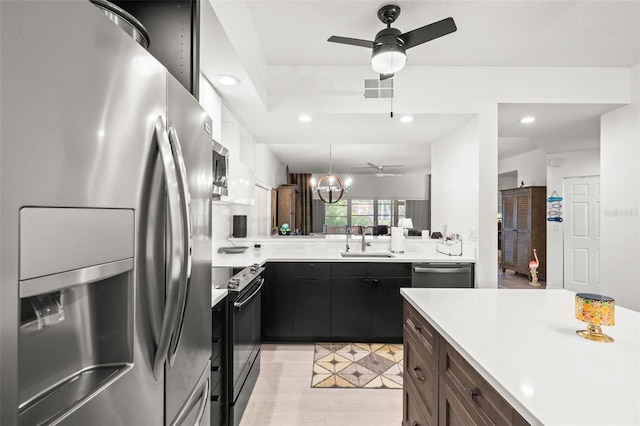 6330 99th Way N Unit 14B, Seminole, FL 33708 - kitchen featuring stainless steel appliances, a ceiling fan, recessed lighting, light countertops, and hanging light fixtures
