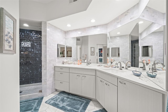 6330 99th Way N Unit 14B, Seminole, FL 33708 - full bath featuring a tile shower, tile patterned flooring, tile walls, double vanity, and recessed lighting