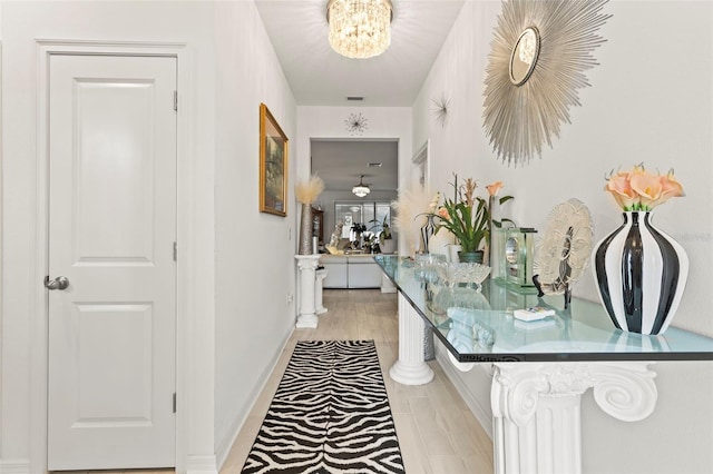 944 Old Windsor Way, Spring Hill, FL 34609 - corridor featuring a chandelier and baseboards