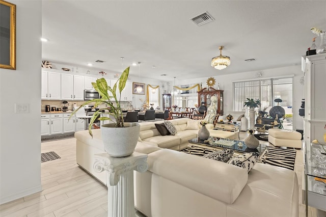 944 Old Windsor Way, Spring Hill, FL 34609 - living room featuring light wood-type flooring and recessed lighting