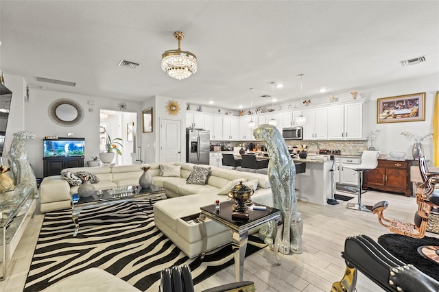 944 Old Windsor Way, Spring Hill, FL 34609 - living room with light wood-style floors, recessed lighting, and a chandelier