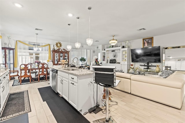 944 Old Windsor Way, Spring Hill, FL 34609 - kitchen with a sink, white cabinets, a chandelier, open floor plan, and stainless steel dishwasher