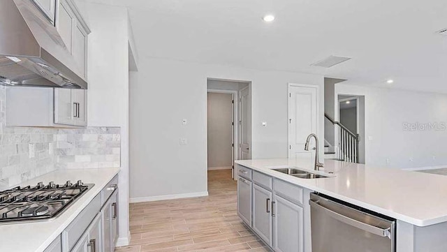 33306 Castaway Loop, Wesley Chapel, FL 33543 - kitchen with under cabinet range hood, appliances with stainless steel finishes, a sink, light countertops, and baseboards
