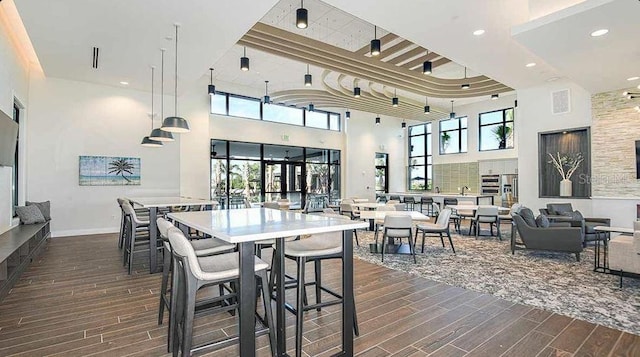 33306 Castaway Loop, Wesley Chapel, FL 33543 - dining space featuring wood finish floors, a high ceiling, recessed lighting, and baseboards