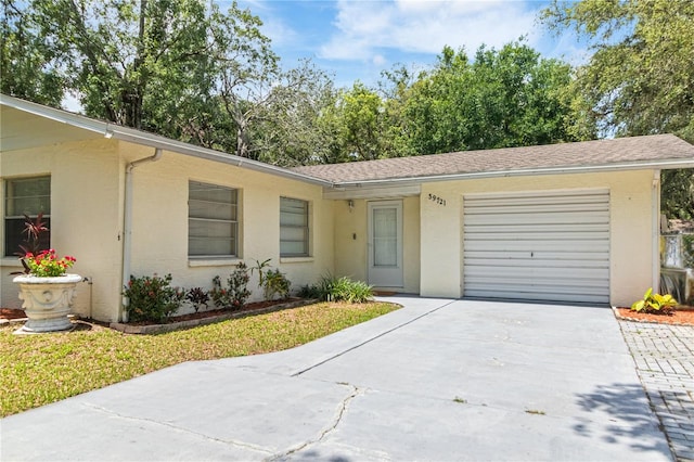 39721 Meadowood Loop, Zephyrhills, FL 33542 - ranch-style house featuring a garage, driveway, and stucco siding