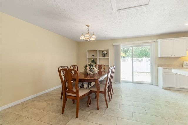39721 Meadowood Loop, Zephyrhills, FL 33542 - dining space with a textured ceiling, a chandelier, light tile patterned floors, and baseboards