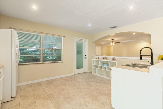 39721 Meadowood Loop, Zephyrhills, FL 33542 - kitchen with a sink, freestanding refrigerator, a ceiling fan, recessed lighting, and arched walkways