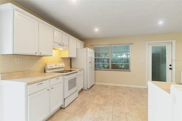 39721 Meadowood Loop, Zephyrhills, FL 33542 - kitchen with white appliances, under cabinet range hood, recessed lighting, white cabinets, and light countertops