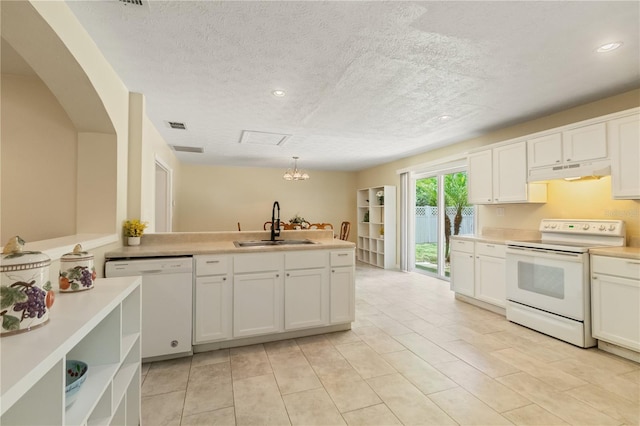 39721 Meadowood Loop, Zephyrhills, FL 33542 - kitchen with white appliances, a sink, under cabinet range hood, a peninsula, and white cabinetry