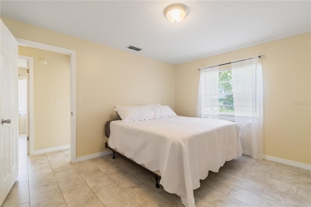 39721 Meadowood Loop, Zephyrhills, FL 33542 - bedroom featuring light tile patterned flooring and baseboards