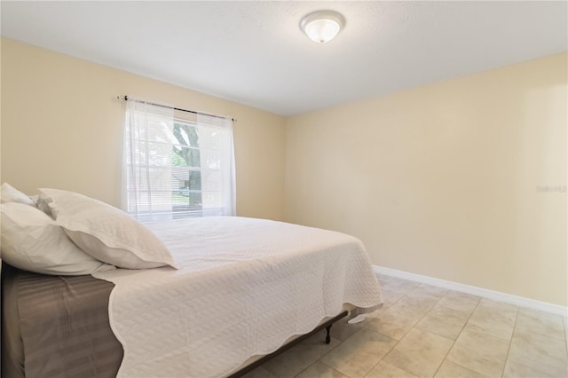39721 Meadowood Loop, Zephyrhills, FL 33542 - bedroom featuring baseboards and light tile patterned floors