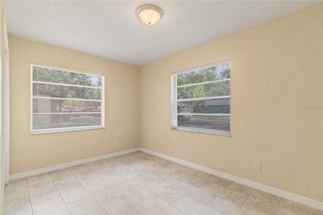 39721 Meadowood Loop, Zephyrhills, FL 33542 - spare room with light tile patterned floors and baseboards