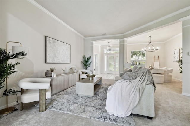 10244 Shadow Branch Dr, Tampa, FL 33647 - living area featuring arched walkways, a chandelier, crown molding, baseboards, and light carpet