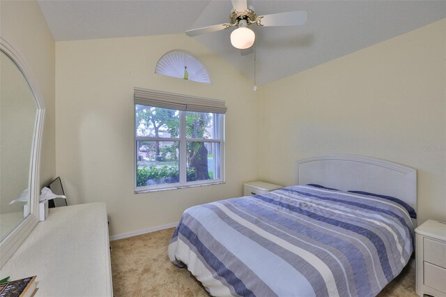 1111 Golfview Woods Dr Unit 1111, Sun City Center, FL 33573 - bedroom featuring light colored carpet, vaulted ceiling, baseboards, and a ceiling fan