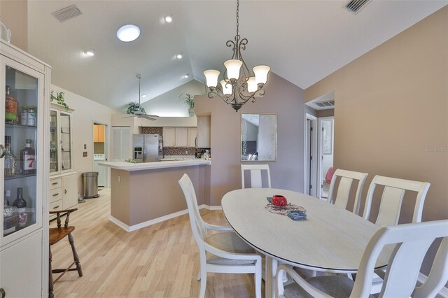 1111 Golfview Woods Dr Unit 1111, Sun City Center, FL 33573 - dining area with lofted ceiling, light wood-style flooring, a chandelier, a ceiling fan, and recessed lighting